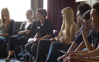 Das Bild zeigt Agnes Sander mit anderen Personen bei einer Veranstaltung der Aktionsgemeinschaft Dienst für den Frieden.
