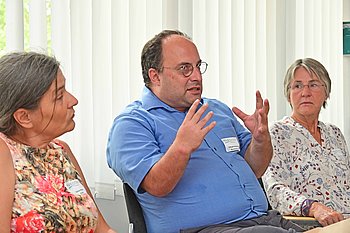 Dariush Ghobad (Mitte) erzählt von seiner Motivation, als Fachkraft in den Entwicklungsdienst zu gehen. Links: Sabine Maier von der AGdD, rechts: Carmen Kugele. Beide sind auch Rückkehrerinnen aus dem Entwicklungsdienst. Foto: Axel Vogel/Amazon